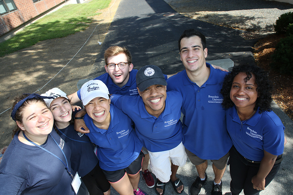 Group of orientation leaders with arms around each other, smiling